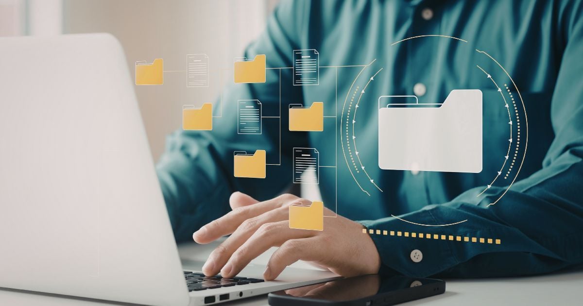 Professional using a laptop with digital folders and documents representing AI-powered document management and information access.